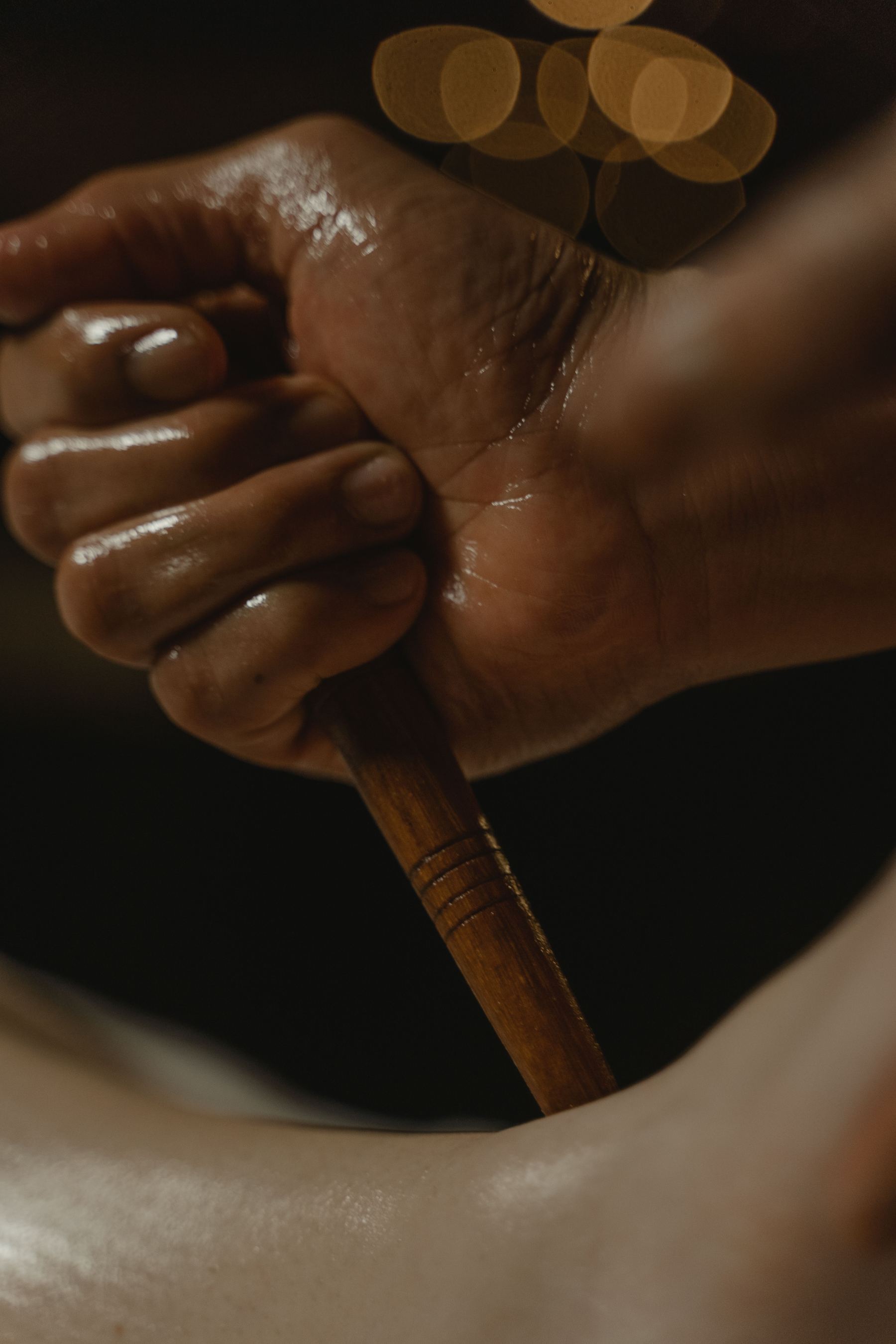 Traditional wooden massage tool with oil