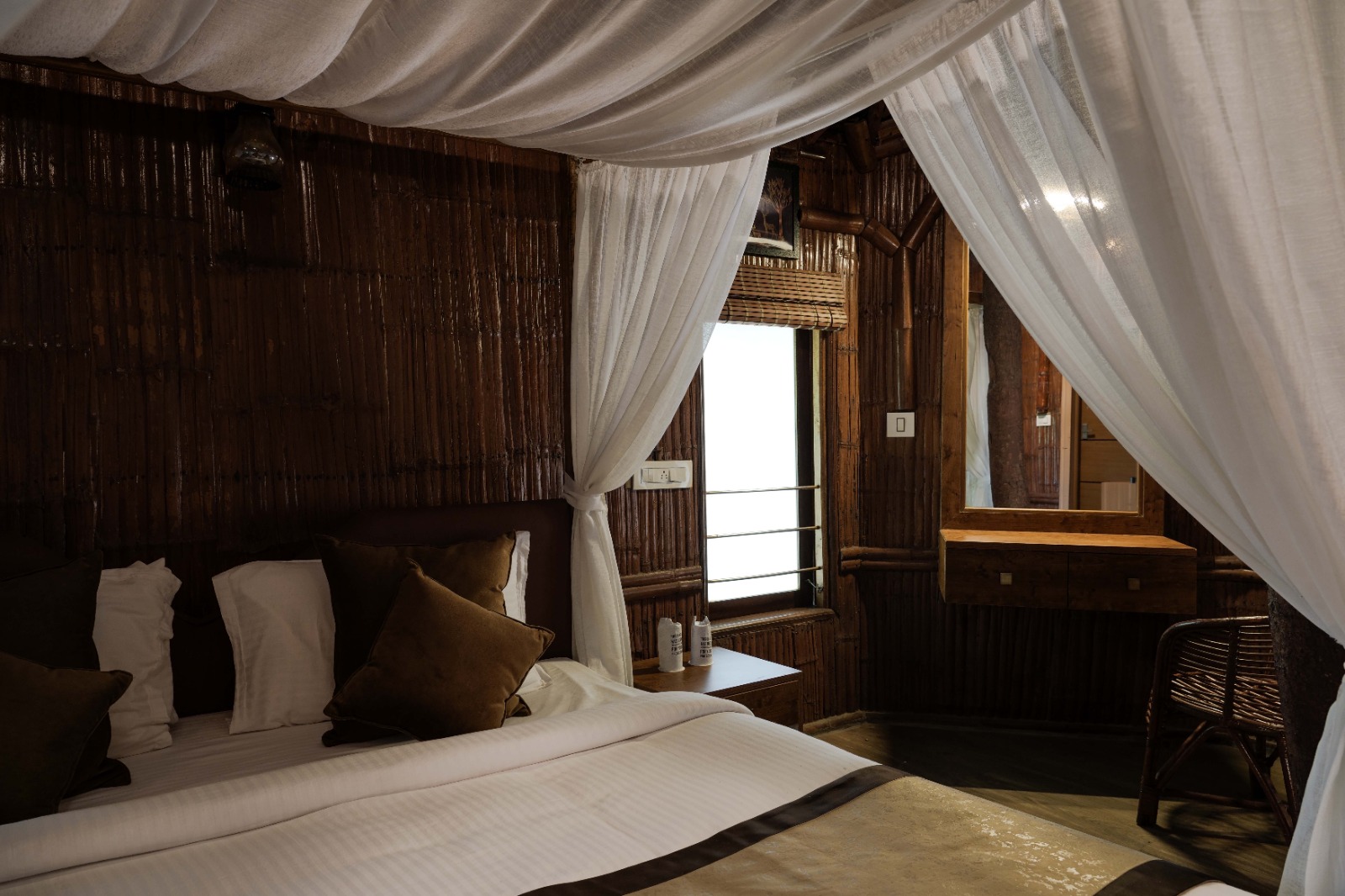 Sheer white canopy drapes over the bed
