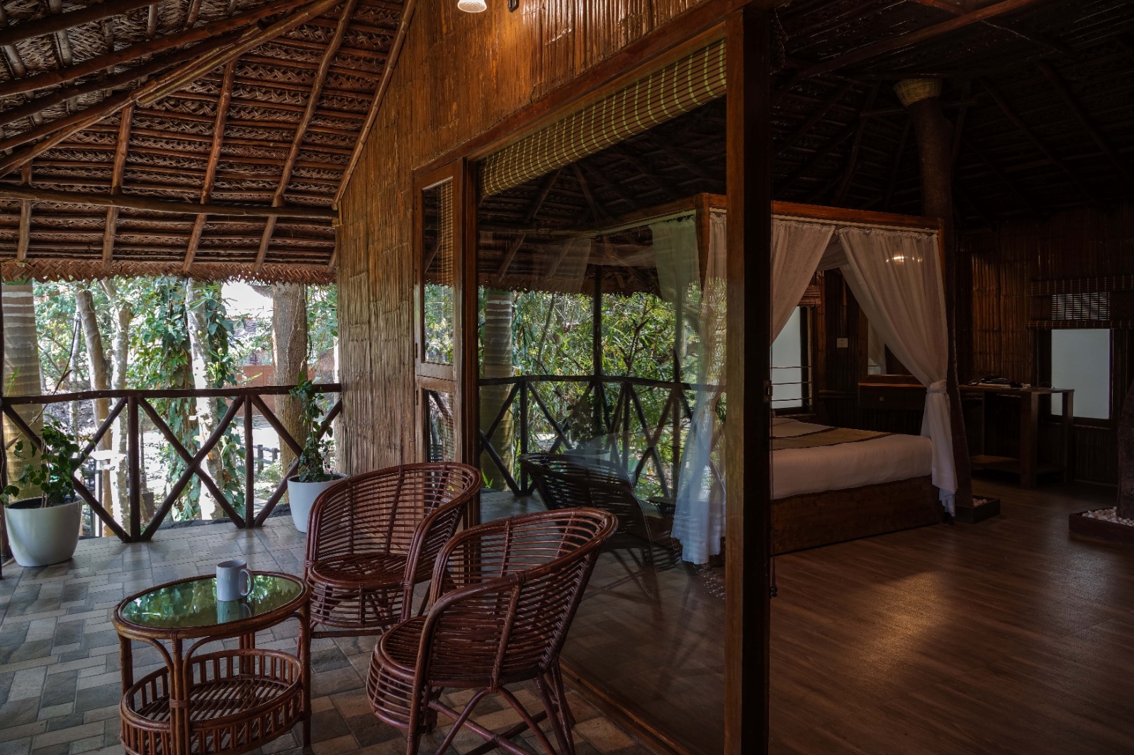 Bamboo Hut veranda with wicker seating opening to the bedroom
