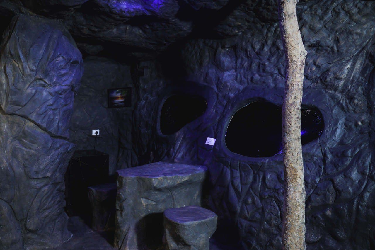 Cave House surrounded by forest at dusk