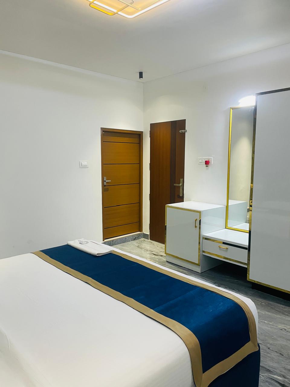 Luxury Villa bedroom with navy and gold bedding